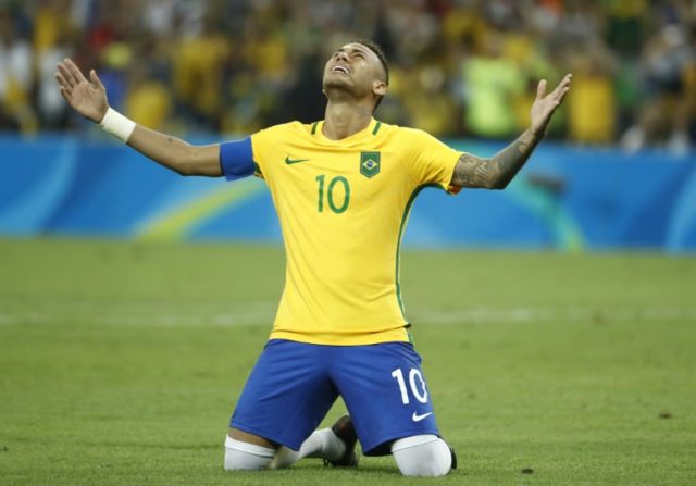 Brazil forward Neymar celebrates scoring the winning penalty during the shoot-out against