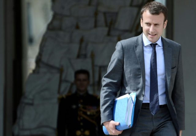 French Economy Minister Emmanuel Macron leaves the Elysee Palace after a weekly cabinet me