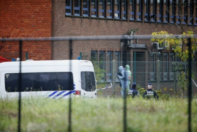 Belgian forensic officers enter the National Institute of Criminology after an explosion o