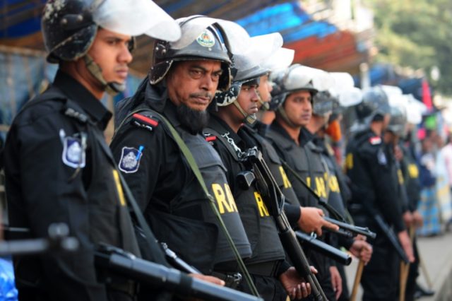 Bangladesh Rapid Action Battalion personnel keep watch during a demonstration in Dhaka