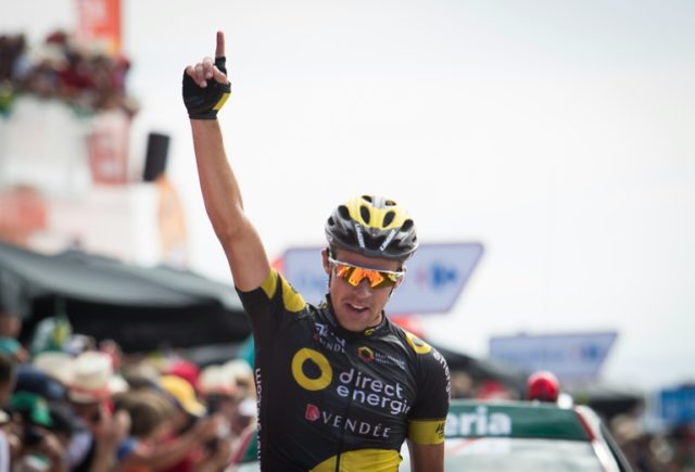 Direct Energie's French cyclist Lilian Calmejane celebrates as he crosses the finish line
