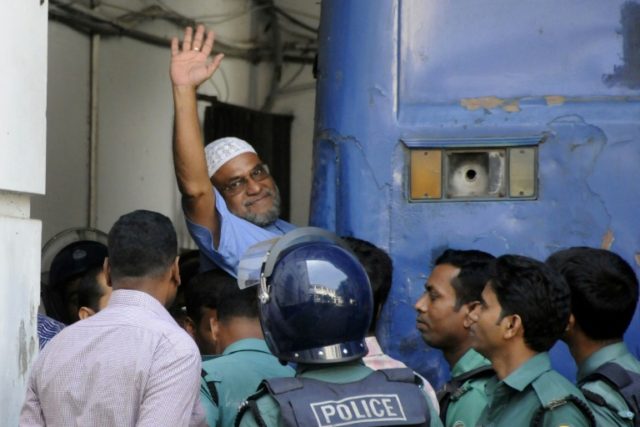 Bangladeshi Jamaat-e-Islami party leader, Mir Quasem Ali waves as he enters a van at the I