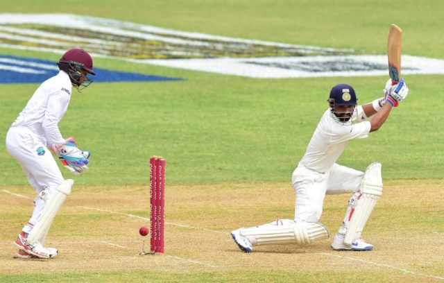 West Indies wicket keeper Shane Dowrich plays close to the wickets as India's Ajinkya Raha