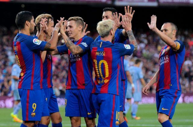 Barcelona's Luis Suarez (L) is congratulated by teammates after scoring a goal during thei