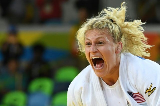 Kayla Harrison celebrates after defeating France's Audrey Tcheumeo during their women's un