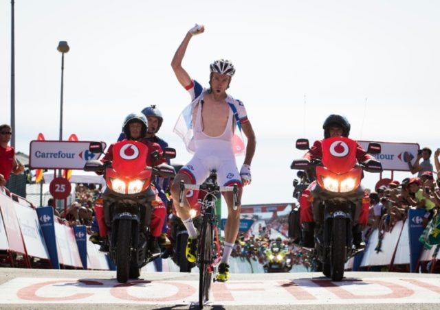 FDJ's French cyclist Alexandre Geniez celebrates winning as he crosses the finish line dur