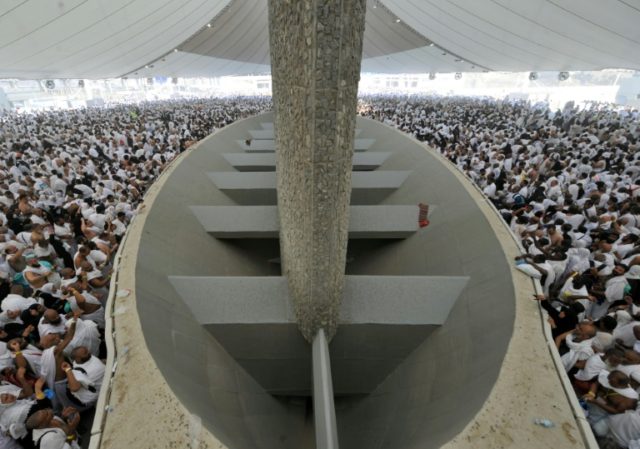 Muslim pilgrims throw pebbles at pillars during the "Jamarat" ritual, the stoning of Satan