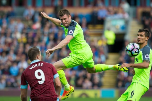 Liverpool's James Milner jumps for the ball as Burnley's Sam Vokes and Liverpool's Dejan L