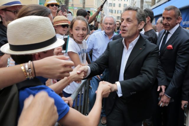 Nicolas Sarkozy greets supporters after a dedication of his book at a library in Ajaccio,