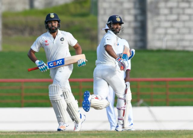 Rohit Sharma (left) and Ajinkya Rahane of India run between the wickets during the 3rd Tes
