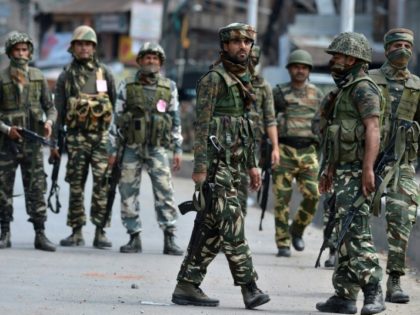 Indian army soldiers gather on a street during a gunfight in Srinagar on August 15, 2016