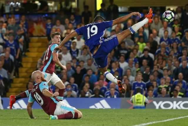 Chelsea's Brazilian-born Spanish striker Diego Costa (R) stretches to reach the ball in th
