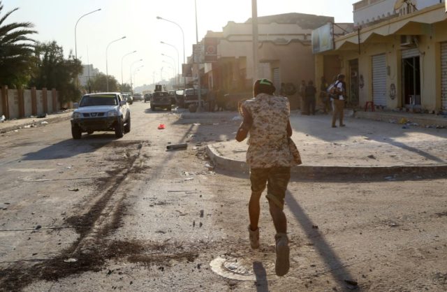 A member of the forces loyal to Libya's UN-backed Government of National Accord runs on a