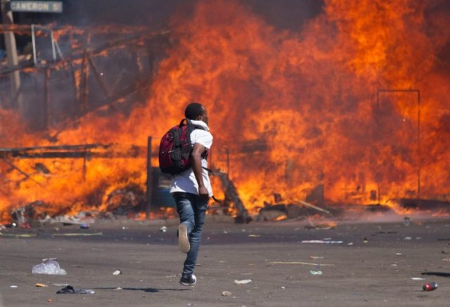 Zimbabwe's opposition supporters set up a burning barricade as they clash with police duri