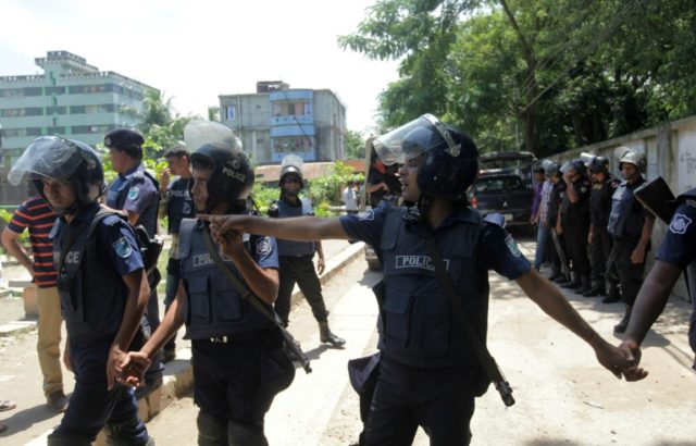 Bangladesh police stand guard around a militant hideout in Narayanganj after it was raided