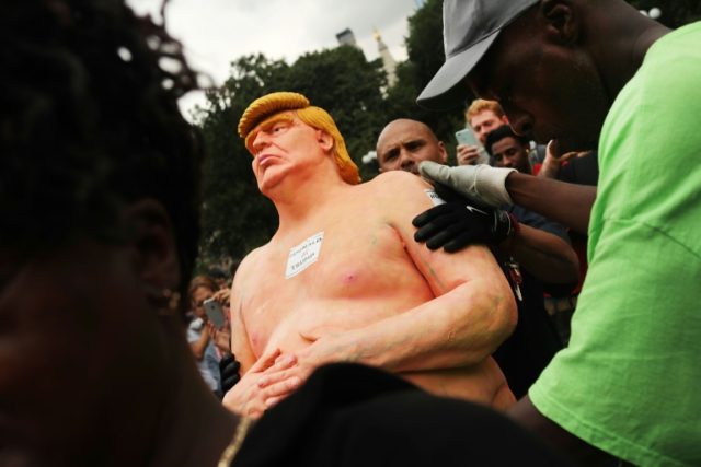 Park authorities haul away a statue of naked Donald Trump that appeared in Union Square Pa
