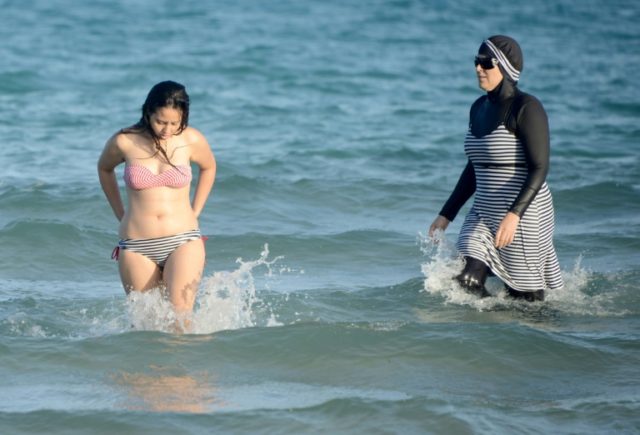 Nice is one of about 15 French towns which has banned the wearing of the burkini (R) on be