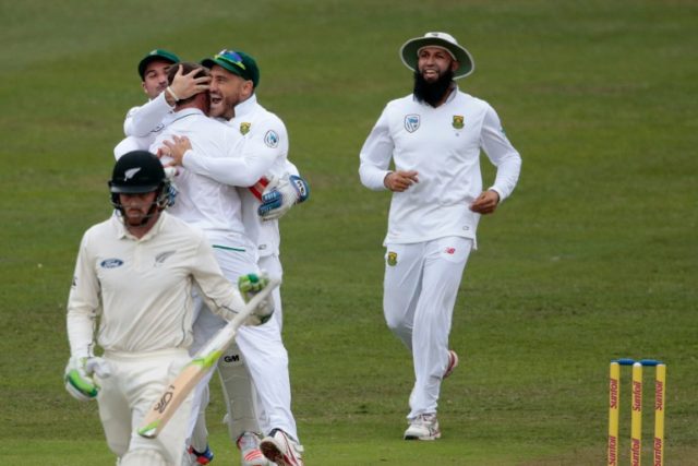 South African players celebrate the dismissal of New Zealand's batsman Martin Guptill (lef