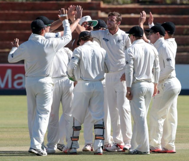 Tim Southee (centre) and teammates celebrate a wicket against Zimbabwe