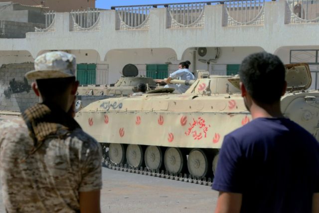 Forces loyal to Libya's UN-backed government gather next to tanks on August 27, 2016 in Si