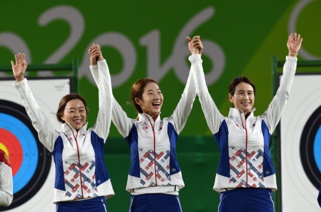 L-R: South Korea's archers Chang Hye-Jin, Choi Mi-Sun and Ki Bo-Bae pose with their gold m