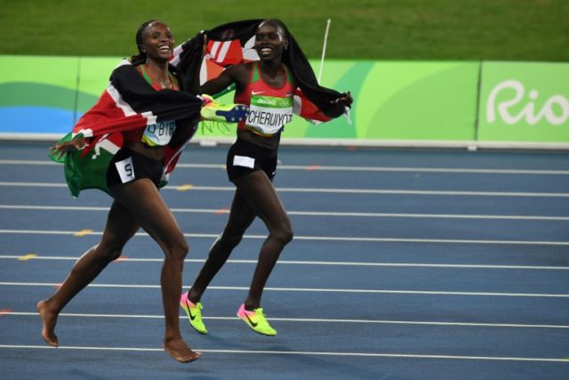 Kenya's Vivian Cheruiyot (R) and Hellen Obiri celebrate after taking gold and silver resp
