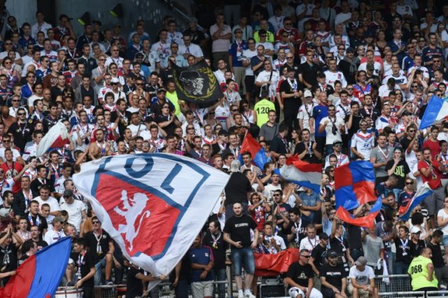 Supporters of the Olympique Lyonnais football club wave flags during a match