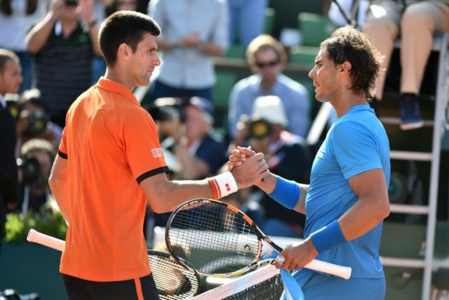 Spain's Rafael Nadal (R) shakes hands with Serbia's Novak Djokovic at the end of their men