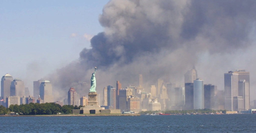 The Statue of Liberty stands as smoke billows from the World Trade Center in New York, Tuesday, Sept 11, 2001 after terrorists crashed two hijacked airliners into the World Trade Center and brought down the twin 110-story towers. (AP Photo/Stuart Ramson)