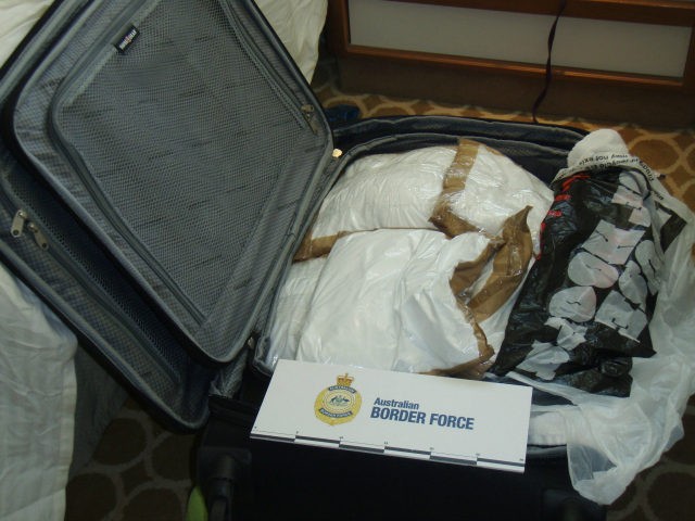 In this photo released by Australia Boarder Force, a suitcase filled with cocaine after it