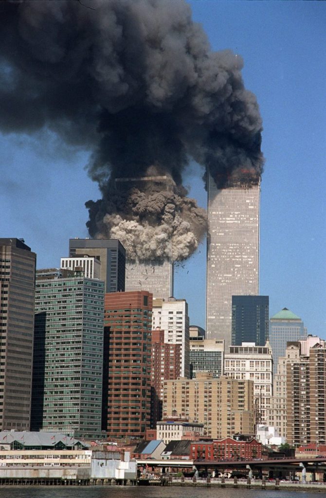 The south tower collapses as smoke billows from both towers of the World Trade Center, in New York, Tuesday, Sept. 11, 2001. In one of the most horrifying attacks ever against the United States, terrorists crashed two airliners into the World Trade Center in a deadly series of blows that brought down the twin 110-story towers. (AP Photo/Jim Collins)