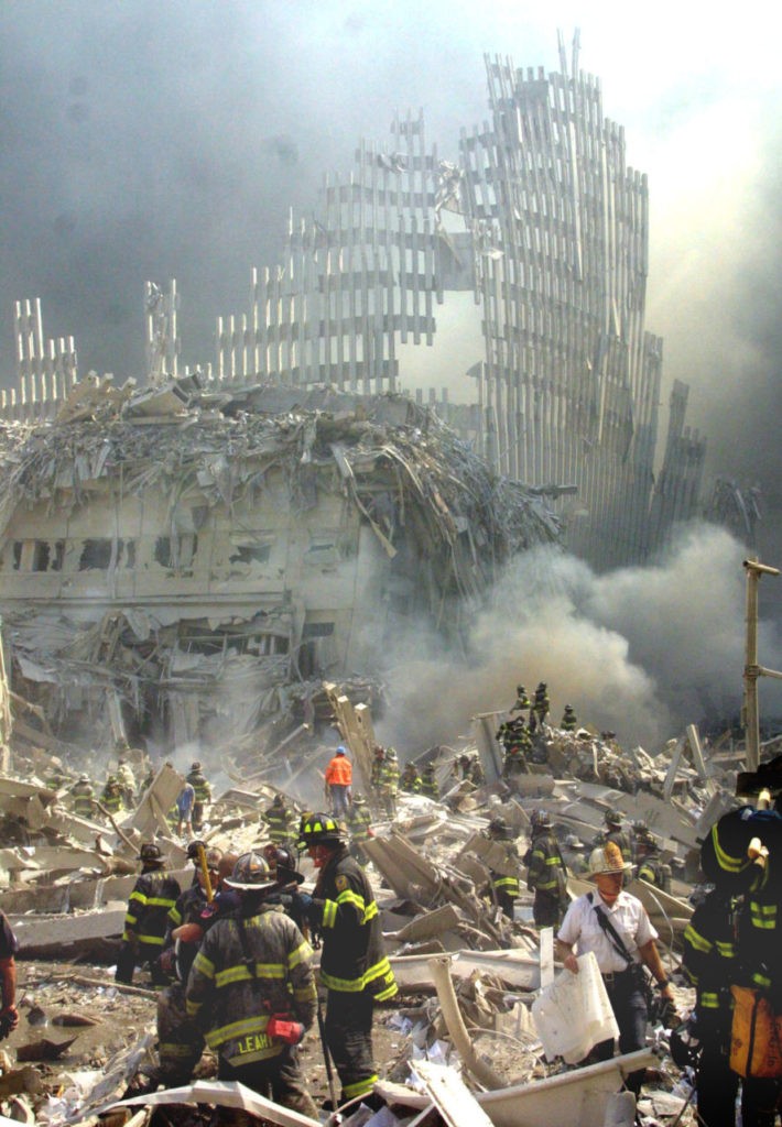 A shell of what was once part of the facade of one of the twin towers of New York's World Trade Center rises above the rubble that remains after both towers were destroyed in a terrorist attack Tuesday, Sept. 11, 2001. The 110-story towers collapsed after two hijacked airliners carrying scores of passengers slammed into the sides of the twin symbols of American capitalism. (AP Photo/Shawn Baldwin)