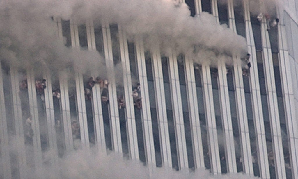 ** FILE ** People hang out of broken windows of the North Tower of the World Trade Center after a terrorist attack in New York on the morning of Sept. 11, 2001. Richard Pecorella has spent years searching for an image he says will bring him peace: a photograph that proves his fiancee, whom he believes could be in this photo, jumped to her death from the burning World Trade Center. (AP Photo/Amy Sancetta, File)