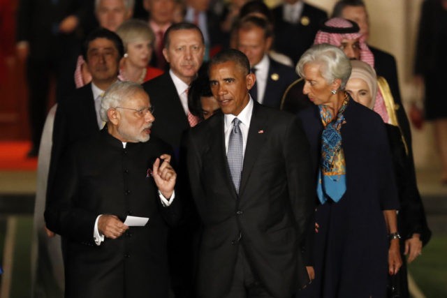 U.S. President Barack Obama, center, chats with Indian Prime Minister Narendra Modi, left,