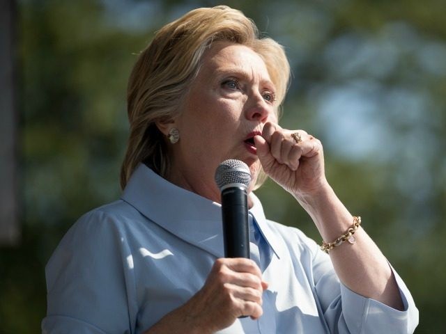 Democratic presidential candidate Hillary Clinton stops her speech to cough at the 11th Co