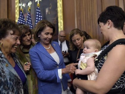 Emily J. Holubowich, right, holds her daughter Jackie, as she talks with, from left, Rep. Nita Lowey, D-N.Y., Rep. Rosa DeLauro, D-N.Y., House Minority Leader Nancy Pelosi of Calif., and Rep. Debbie Wasserman-Schultz, D-Fla., following a news conference about the Zika virus on Capitol Hill in Washington, Wednesday, Sept. 7, …