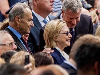 Democratic presidential candidate Hillary Clinton, center, accompanied by Sen. Chuck Schumer, D-N.Y., left, and Rep. Joseph Crowley, D-N.Y., second from left, speaks with New York Mayor Bill de Blasio, center right, during a ceremony at the Sept. 11 memorial, in New York, Sunday, Sept. 11, 2016. (AP Photo/Andrew Harnik)