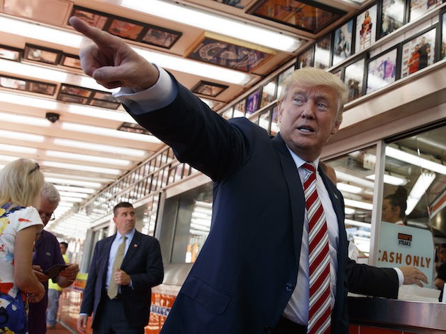 Republican presidential candidate Donald Trump talks with customers during a visit to Geno