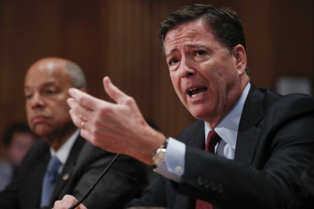 FBI Director James Comey, right, responds to questioning from Senate Homeland Security and