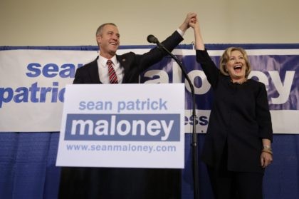 Rep. Sean Maloney holds hands with former Secretary of State Hillary Rodham Clinton during