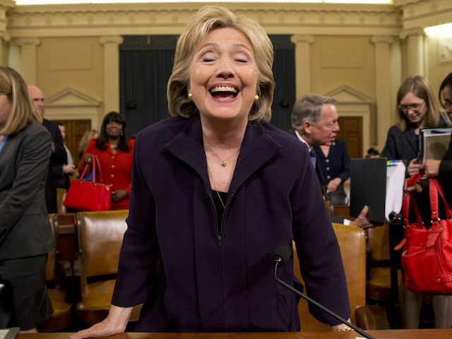 Democratic presidential candidate and former Secretary of State Hillary Rodham Clinton laughs as she stands up at the end of her testimony on Capitol Hill in Washington, Thursday, Oct. 22, 2015, before the House Select Committee on Benghazi. (AP Photo/Jacquelyn Martin)