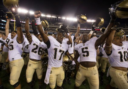PHILADELPHIA, PA - SEPTEMBER 02: Quinten Parker #85, Richard Hanson #26, Ahmad Bradshaw #17, Joe Walker #5, and Gervon Simon #10of the Army Black Knights celebrate after the game against the Temple Owls at Lincoln Financial Field on September 2, 2016 in Philadelphia, Pennsylvania. The Black Knights defeated the Owls …
