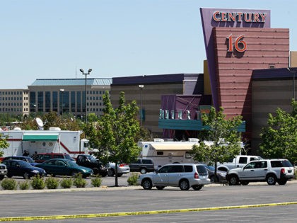 FILE - In this July 21, 2012 file photo, police and other vehicles remain in front of the Century 16 movie theater in Aurora, Colo. Relatives of the majority of people killed at the movie theater last July rejected an invitation on Wednesday, Jan. 2, 2013 to attend its reopening …