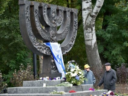 Men react during a visit to the Babi Yar menorah monument in Kiev on September 23, 2016. Ukraine will mark the 75th anniversary next week of the September 1941 mass executions at Babi Yar, in Kiev, of Jews by the Nazis during WWII. Some 34,000 Jews were murdered over two …