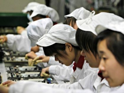 Staffs works on the production line at the Foxconn complex in the southern Chinese city of