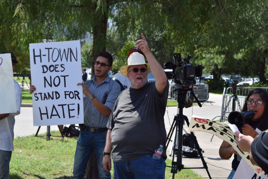 Former professor David Michael Smith, in hat, chants anti-Trump slogans. (Photo: Bob Price/Breitbart Texas)