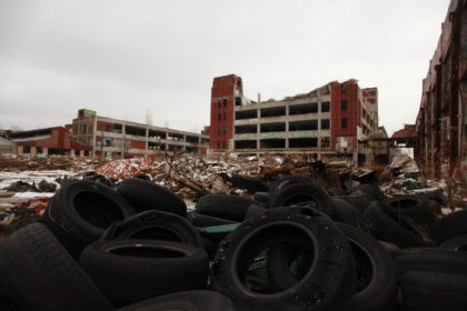 DETROIT, MI- DECEMBER 13: Old tires rest near the abandoned Packard Automotive Plant December 13, 2013 in Detroit, Michigan. Peru-based developer Fernando Palazuelo made his final payment on the Packard Plant, which he won during a Wayne County auction for $405,000. Palazuelo plans on developing the former automotive plant where …