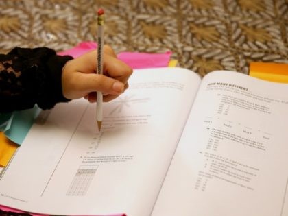 Suzane Nazir uses a Princeton Review SAT Preparation book to study for the test on March 6