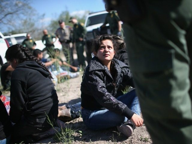Border Patrol questions an undocumented immigrant from El Salvador after she illegally crossed the U.S.-Mexico border and was caught with a group of fellow immigrants on December 7, 2015 near Rio Grande City, Texas.