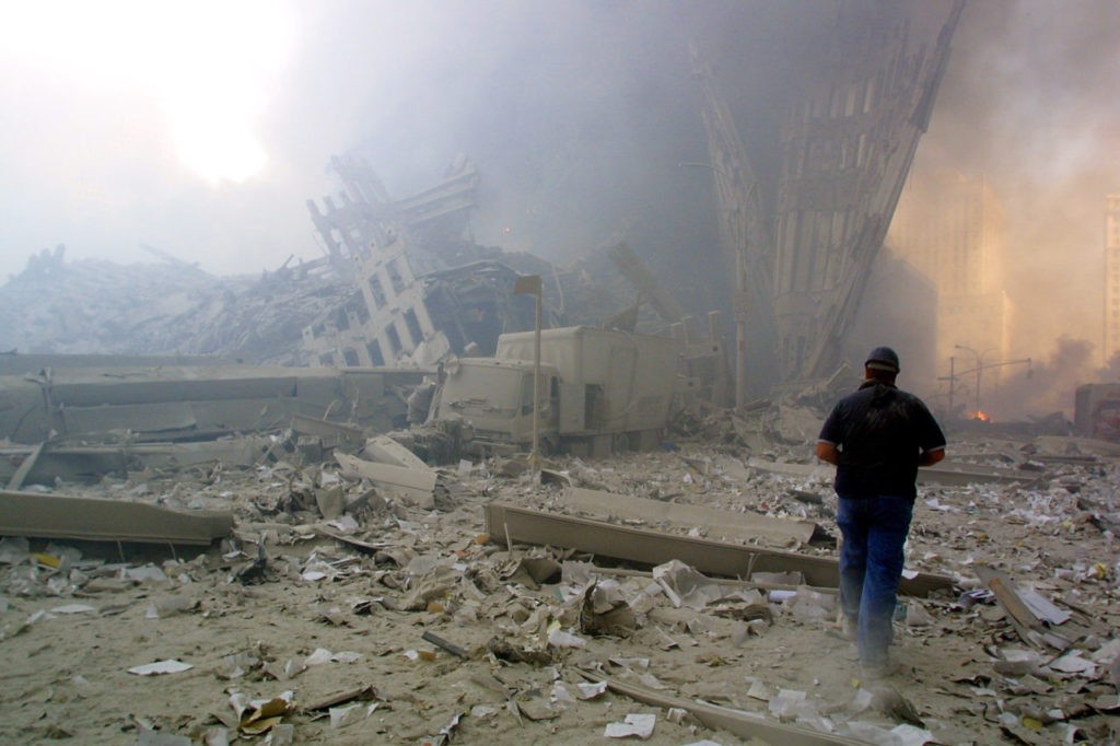 NEW YORK, UNITED STATES: A man walks through the rubble after the collapse of the first World Trade Center Tower 11 September, 2001 in New York. AFP PHOTO Doug KANTER (Photo credit should read DOUG KANTER/AFP/Getty Images)